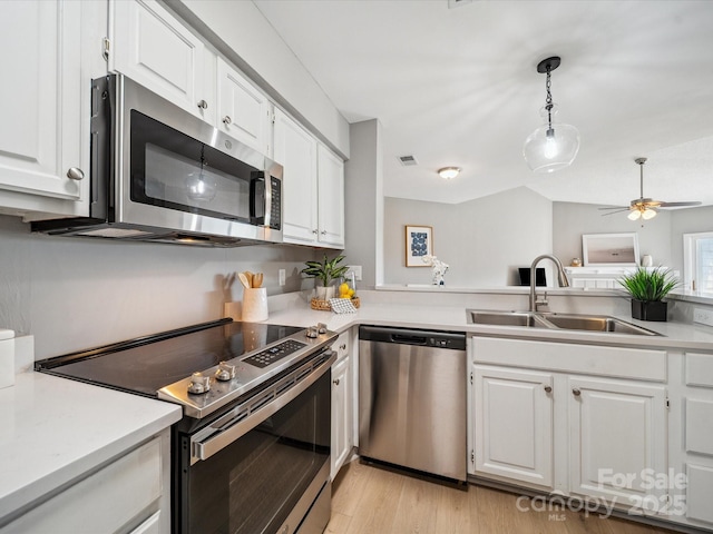 18817 Nautical Dr Unit 302, Cornelius, NC 28031 - kitchen featuring stainless steel appliances, light countertops, white cabinetry, and a ceiling fan