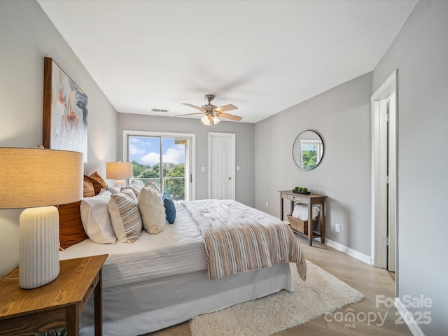 18817 Nautical Dr Unit 302, Cornelius, NC 28031 - bedroom featuring access to outside, light wood-style floors, and ceiling fan