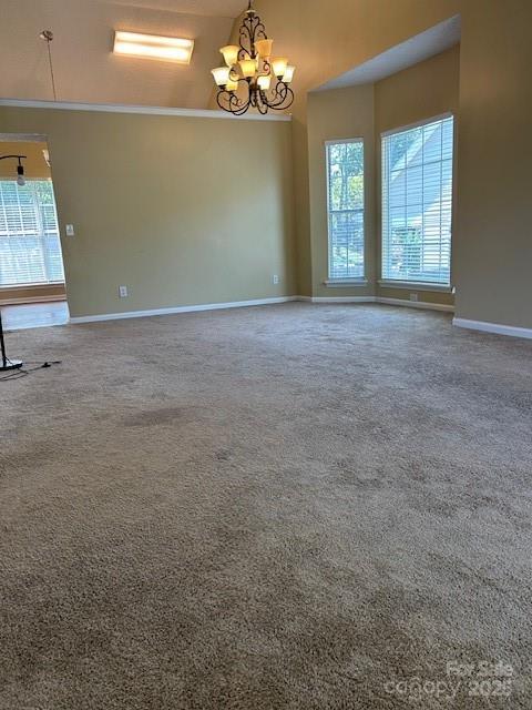 8901 Clifton Meadow Dr, Matthews, NC 28105 - carpeted spare room featuring a chandelier and a towering ceiling