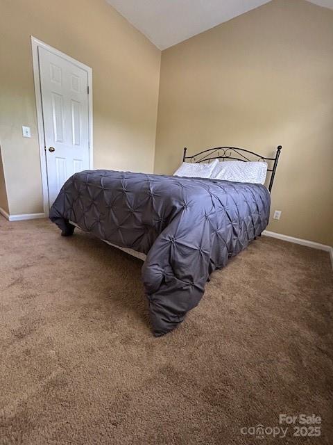 8901 Clifton Meadow Dr, Matthews, NC 28105 - carpeted bedroom with lofted ceiling and baseboards