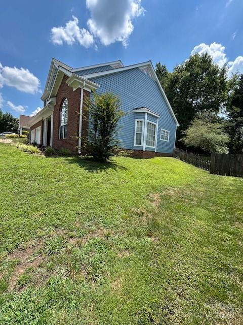 8901 Clifton Meadow Dr, Matthews, NC 28105 - view of home's exterior featuring an attached garage and brick siding