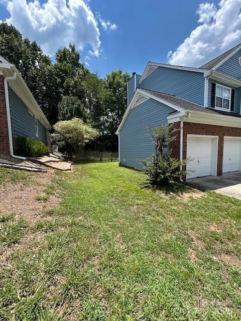 8901 Clifton Meadow Dr, Matthews, NC 28105 - view of yard featuring driveway and an attached garage