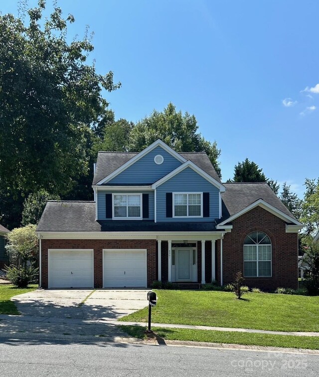 8901 Clifton Meadow Dr, Matthews, NC 28105 - view of front of property with driveway, a front yard, brick siding, a porch, and an attached garage