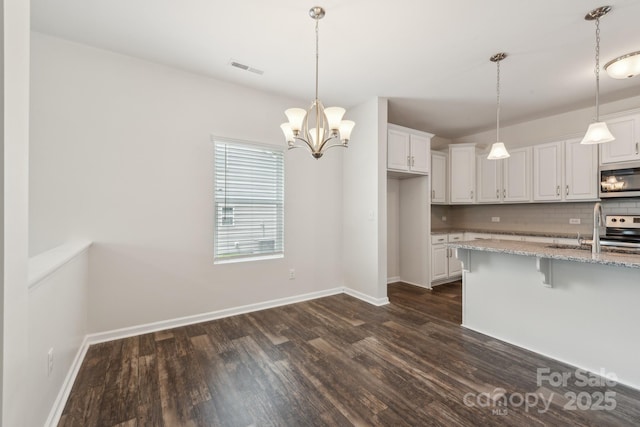 3107 Riker St, Clover, SC 29710 - kitchen featuring stainless steel appliances, dark wood-type flooring, a sink, a kitchen breakfast bar, and white cabinets
