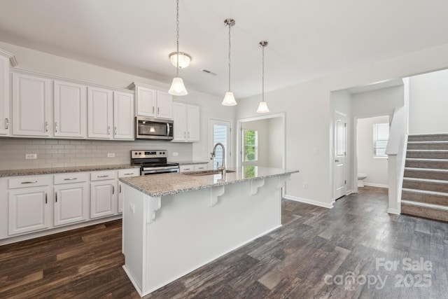 3107 Riker St, Clover, SC 29710 - kitchen featuring stainless steel appliances, a sink, dark wood-style floors, tasteful backsplash, and white cabinets