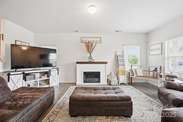 3951 Tersk Dr, Midland, NC 28107 - living area with wood finished floors, baseboards, and a glass covered fireplace