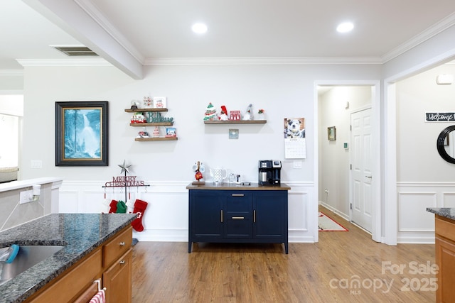 16142 Commodore Dr, Lancaster, SC 29720 - bar area featuring light wood finished floors, a decorative wall, crown molding, a wainscoted wall, and a sink