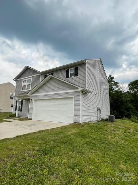323 J C Dellinger Rd, Cherryville, NC 28021 - view of front of property featuring concrete driveway, a garage, a front yard, and cooling unit