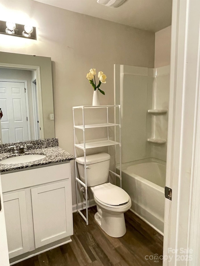 323 J C Dellinger Rd, Cherryville, NC 28021 - bathroom with wood finished floors, toilet, vanity, and  shower combination