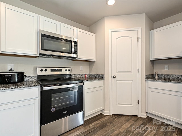 323 J C Dellinger Rd, Cherryville, NC 28021 - kitchen with appliances with stainless steel finishes, dark wood finished floors, white cabinetry, dark stone countertops, and recessed lighting