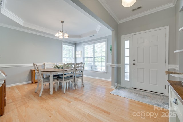 14727 Brannock Hills Dr, Charlotte, NC 28278 - foyer featuring baseboards, light wood-style floors, crown molding, a chandelier, and a raised ceiling