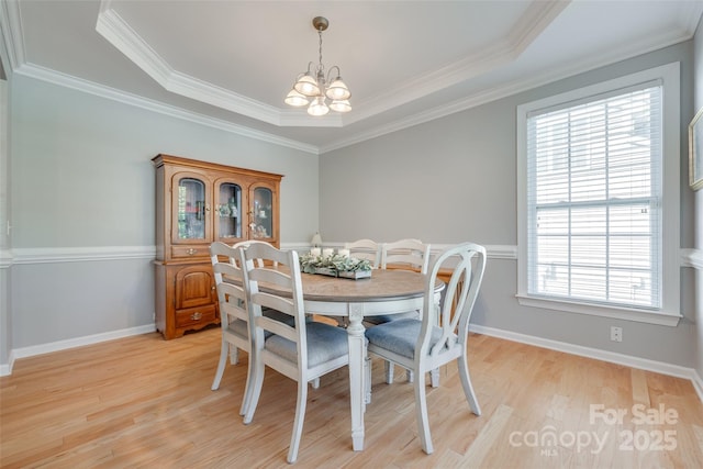 14727 Brannock Hills Dr, Charlotte, NC 28278 - dining area with a chandelier, light wood-style flooring, a raised ceiling, crown molding, and baseboards