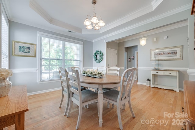 14727 Brannock Hills Dr, Charlotte, NC 28278 - dining space with a chandelier, light wood-style floors, ornamental molding, a raised ceiling, and baseboards