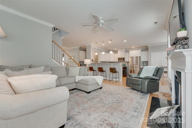 14727 Brannock Hills Dr, Charlotte, NC 28278 - living area featuring ornamental molding, stairs, light wood-style floors, ceiling fan, and recessed lighting