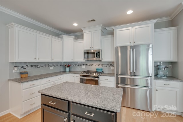 14727 Brannock Hills Dr, Charlotte, NC 28278 - kitchen with stainless steel appliances, white cabinetry, decorative backsplash, light stone countertops, and crown molding