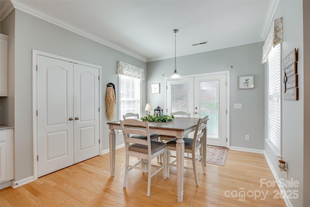 14727 Brannock Hills Dr, Charlotte, NC 28278 - dining room featuring light wood-style floors, french doors, healthy amount of natural light, and crown molding