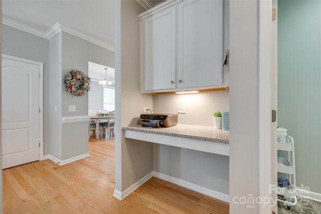 14727 Brannock Hills Dr, Charlotte, NC 28278 - kitchen featuring crown molding, light wood-style flooring, light countertops, white cabinetry, and baseboards