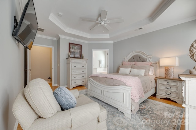 14727 Brannock Hills Dr, Charlotte, NC 28278 - bedroom featuring a tray ceiling, ornamental molding, light wood-style flooring, ensuite bathroom, and a ceiling fan