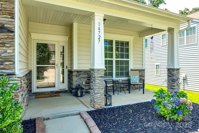 14727 Brannock Hills Dr, Charlotte, NC 28278 - doorway to property with stone siding and covered porch