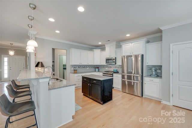 14727 Brannock Hills Dr, Charlotte, NC 28278 - kitchen featuring stainless steel appliances, a kitchen island with sink, decorative backsplash, white cabinets, and crown molding