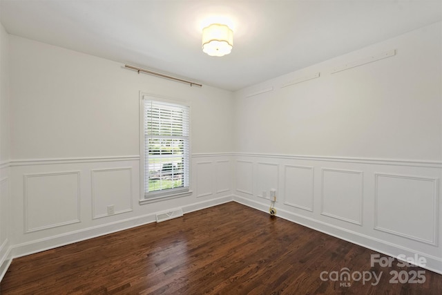 6938 Wrentree Dr, Charlotte, NC 28210 - spare room featuring dark wood-type flooring, a wainscoted wall, and a decorative wall