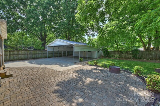 6938 Wrentree Dr, Charlotte, NC 28210 - view of patio featuring a carport and driveway