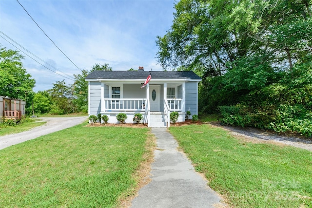 515 Myrtle Ave, Chester, SC 29706 - bungalow with covered porch, a front lawn, and a chimney