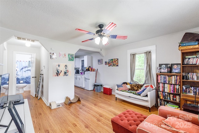 515 Myrtle Ave, Chester, SC 29706 - living area featuring light wood-type flooring, a ceiling fan, baseboards, and a textured ceiling