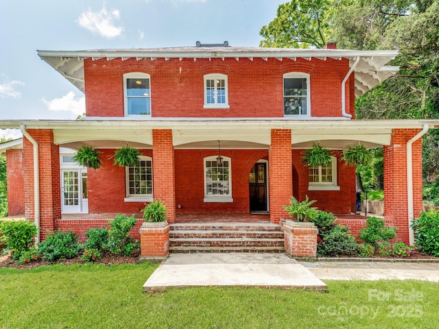 128 W End St, Chester, SC 29706 - view of front of property with a front lawn, brick siding, and a porch
