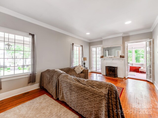 128 W End St, Chester, SC 29706 - living room with wood-type flooring, healthy amount of natural light, baseboards, a fireplace with flush hearth, and ornamental molding