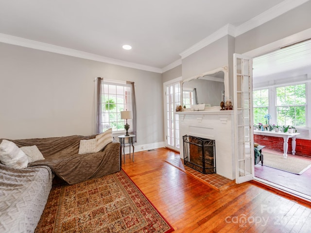 128 W End St, Chester, SC 29706 - living room with wood finished floors, healthy amount of natural light, ornamental molding, a fireplace with raised hearth, and recessed lighting