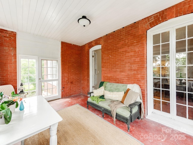 128 W End St, Chester, SC 29706 - sunroom featuring concrete flooring, french doors, brick wall, wooden ceiling, and arched walkways
