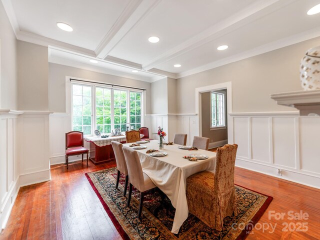 128 W End St, Chester, SC 29706 - dining space with a decorative wall, a wainscoted wall, beamed ceiling, wood-type flooring, and ornamental molding