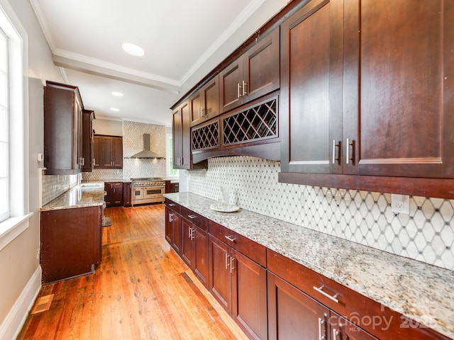 128 W End St, Chester, SC 29706 - kitchen featuring range with two ovens, light wood-style floors, wall chimney exhaust hood, backsplash, and crown molding