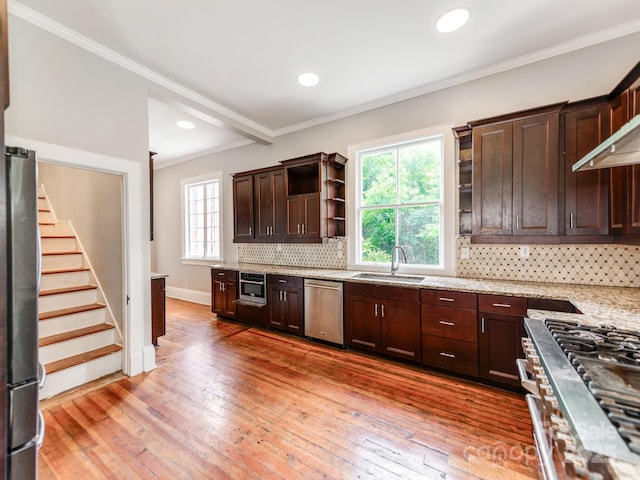 128 W End St, Chester, SC 29706 - kitchen with appliances with stainless steel finishes, a sink, dark brown cabinetry, crown molding, and tasteful backsplash