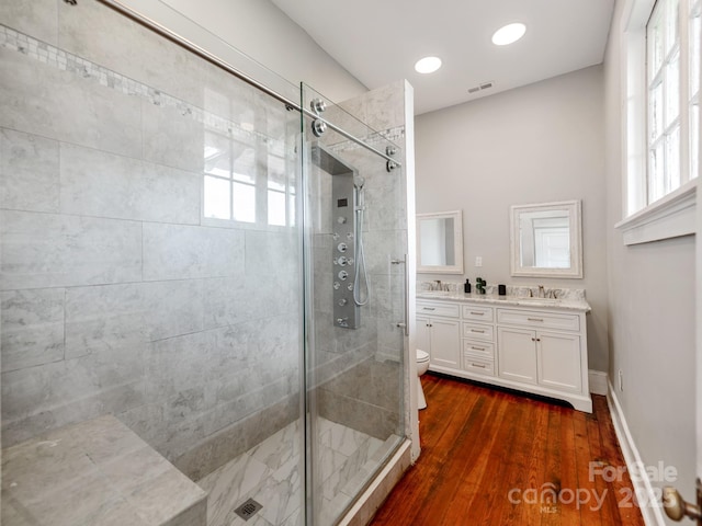 128 W End St, Chester, SC 29706 - bathroom featuring a shower stall, double vanity, wood finished floors, plenty of natural light, and recessed lighting