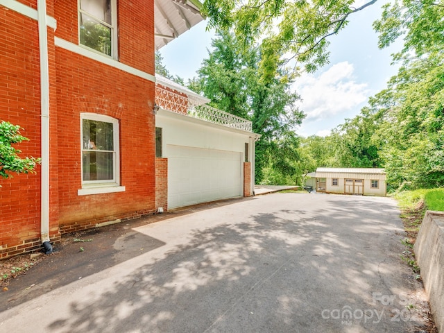 128 W End St, Chester, SC 29706 - view of home's exterior with brick siding, an attached garage, and driveway