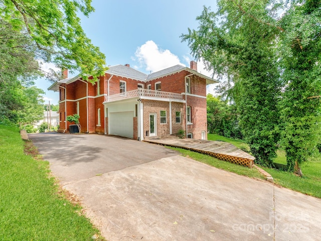 128 W End St, Chester, SC 29706 - view of front of home featuring a chimney, a balcony, brick siding, driveway, and a garage