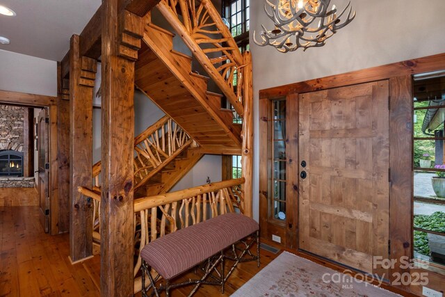 610 Rocky Pkwy Unit 52, 47A, Banner Elk, NC 28604 - foyer featuring hardwood / wood-style flooring, stairway, a chandelier, a stone fireplace, and recessed lighting