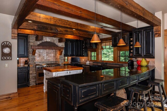 610 Rocky Pkwy Unit 52, 47A, Banner Elk, NC 28604 - kitchen featuring dark cabinetry, high end stainless steel range oven, hardwood / wood-style floors, tasteful backsplash, and butcher block counters