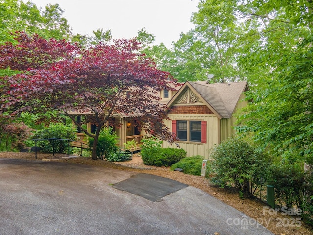 172 Juneberry Ln, Tuckasegee, NC 28783 - view of front of house featuring roof with shingles, a porch, and asphalt driveway