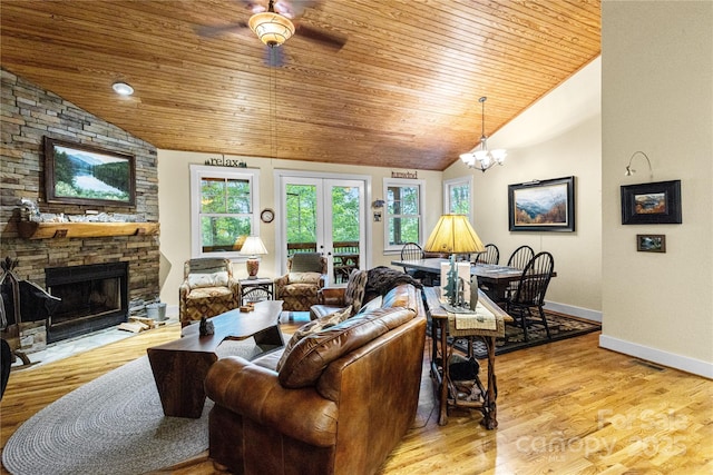 172 Juneberry Ln, Tuckasegee, NC 28783 - living room with wooden ceiling, ceiling fan, a stone fireplace, baseboards, and light wood finished floors