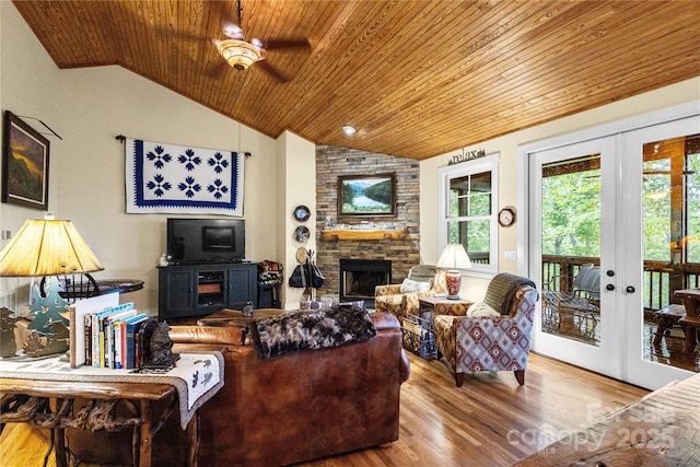 172 Juneberry Ln, Tuckasegee, NC 28783 - living room featuring wood ceiling, lofted ceiling, french doors, wood finished floors, and a stone fireplace