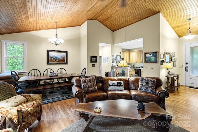 172 Juneberry Ln, Tuckasegee, NC 28783 - living area with lofted ceiling, wood ceiling, light wood-style floors, and a chandelier
