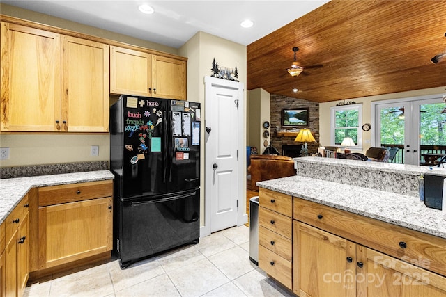 172 Juneberry Ln, Tuckasegee, NC 28783 - kitchen with freestanding refrigerator, light tile patterned floors, light stone countertops, vaulted ceiling, and recessed lighting