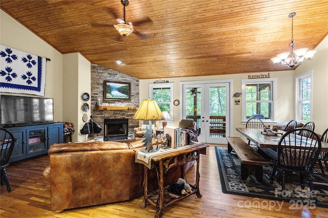 172 Juneberry Ln, Tuckasegee, NC 28783 - living area featuring wood ceiling, lofted ceiling, a stone fireplace, wood finished floors, and plenty of natural light