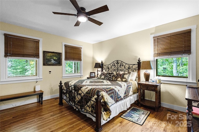 172 Juneberry Ln, Tuckasegee, NC 28783 - bedroom with multiple windows and wood finished floors