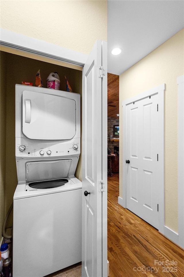 172 Juneberry Ln, Tuckasegee, NC 28783 - laundry room with stacked washing machine and dryer and wood finished floors