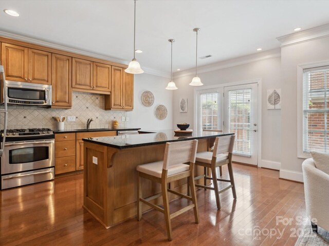 705 Congressional Ln, Fort Mill, SC 29708 - kitchen with stainless steel appliances, hardwood / wood-style floors, a sink, decorative backsplash, and crown molding