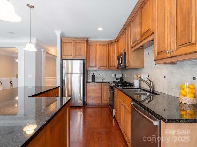 705 Congressional Ln, Fort Mill, SC 29708 - kitchen featuring appliances with stainless steel finishes, a sink, brown cabinets, crown molding, and decorative columns